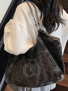 Deep blue acid wash denim tote bag with chain strap and white embroidery on shoulder