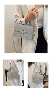 Detail view of small square crossbody bag with lychee texture and golden U-shaped lock