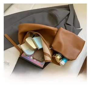 Spacious interior of brown pebbled leather bucket bag showing capacity for daily essentials