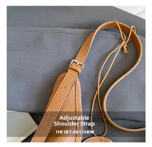 Detail of adjustable brown litchi leather strap with silver buckle and sleek oil edge