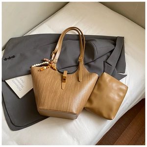 Detail of camel woven tote bag with matching inner pouch and adjustable strap