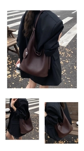 Detail of dark brown pebble leather tote bag featuring a knotted strap and urban street style