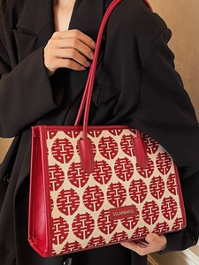 Elegant red tote bag with festive jacquard pattern and premium leather handles for women