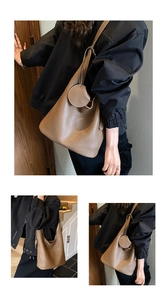 Three-way view of a brown pebbled leather bucket bag with a round charm detail