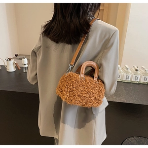Brown fluffy faux fur Boston bag featuring a leather handle and a slender shoulder strap
