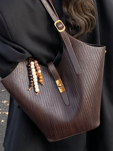 Brown woven hobo bag with tassel and gold buckle strap for stylish autumn commute