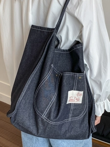Large capacity dark blue denim tote bag with dual front pockets and contrast stitching