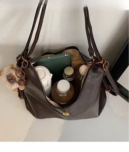 Interior view showing the large capacity of the dark brown tote bag with daily items