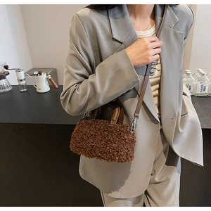 Detail of dark brown faux lamb fur Boston bag with plush texture and silver metal buckles