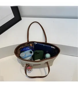Top view of spacious canvas tote bag interior with tablet, phone, and daily essentials