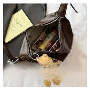 Top-down view of spacious dark brown tote bag interior with adjustable strap