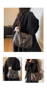 Detailed view of brown leather tote bag with soft texture and white plush animal charm