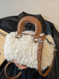 White sherpa Boston bag with brown leather handles and a silver metal buckle for women