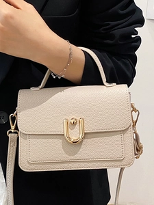 Chic beige lychee grain handbag with gold U-shaped buckle and adjustable strap