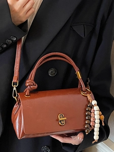 Classic dark brown vintage leather handbag with gold buckle and beaded charm for women