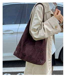 Detailed laser-cut flower patterns on dark brown faux suede tote bag for women