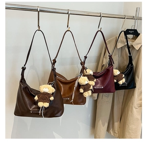 Detailed comparison of four hobo bags with teddy bear charms in multiple colors