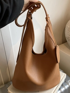 Minimalist brown lychee pattern leather bucket bag with top handle and shoulder strap