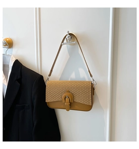 Detail view of caramel crossbody bag with straw-woven texture and retro buckle