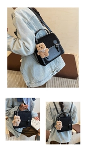 Detail view of black quilted faux leather backpack with teddy bear charm decoration