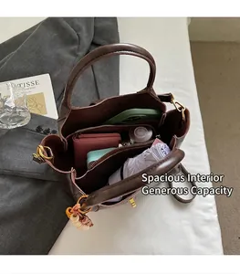 Top view of spacious dark brown leather tote interior with zipper pocket and essentials