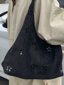 Chic black hollow-out tote bag with floral laser-cut patterns for casual commuting women