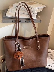 Brown retro leather tote bag for women with golden hardware and cute teddy bear pendant