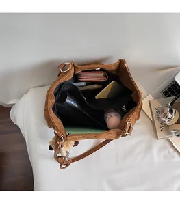 Detailed top view of brown suede tote bag interior with large capacity storage