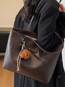 Large dark brown leather tote bag for women with a cute puppy plush charm for daily commuting
