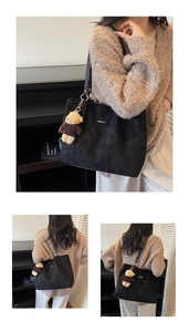 Detail view of black woven tote bag featuring a cute teddy bear plush charm and matte finish