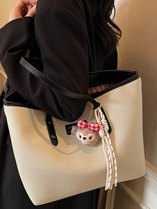 Fashionable contrast canvas tote bag for women with leather trim and plush charm
