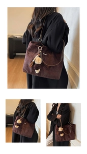 Detailed view of dark brown quilted tote bag with soft suede texture and cute bear charm