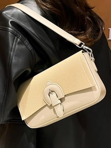 Minimalist beige crossbody bag with mixed suede texture and silver hardware