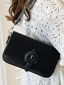 Minimalist black square crossbody bag in mixed leather and textured fabric with strap