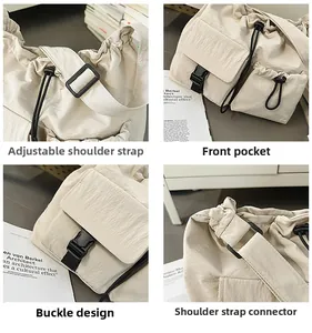 Detail view of beige nylon bucket bag with adjustable wide strap and buckle pocket