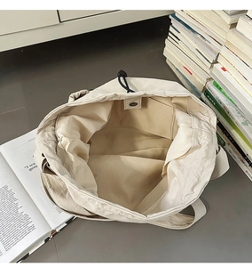 Detailed top view showing drawstring closure, magnetic buckle and spacious interior pocket