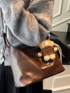Retro deep brown leather tote bag with a cute teddy bear charm and fashion label
