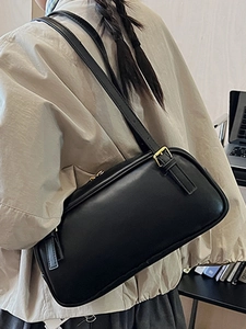 Classic black leather baguette bag for women with gold hardware and adjustable strap