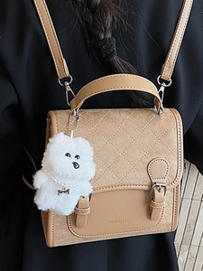 Brown quilted leather backpack for women with flap buckle and plush dog pendant