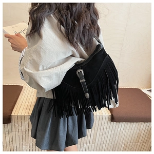 Sac hobo noir rétro à franges avec boucle argentée dans une scène de style de vie