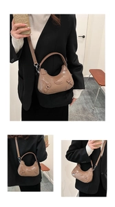 Detail showing the adjustable straps and silver metal hardware on a taupe crescent bag