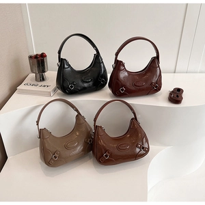 Stack of four glossy moon bags in black, burgundy, khaki and caramel faux leather