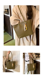 Detail of olive green woven tote bag with leather texture and colorful beaded charm