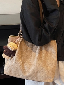 Minimalist light brown quilted tote bag for women with woven texture and teddy bear charm