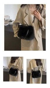 Detail of plush black faux fur handbag with leather handle and light gold hardware
