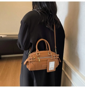 Caramel leather Boston bag with metal double buckles and a cartoon bear card holder