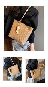 Detail of a large woven tote bag with a colorful beaded charm and slim shoulder straps