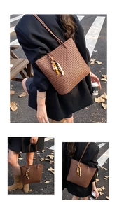 Detailed close-up of dark brown woven tote bag with checkerboard pattern and beads