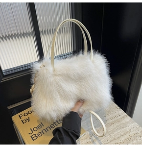 Detail of white faux fur tote bag with golden metal hooks and adjustable strap