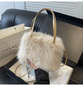 Detailed view of the plush beige faux fur tote bag with long brown leather handles